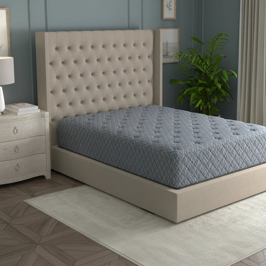 Beige upholstered bed with a gray mattress in a bedroom setting.